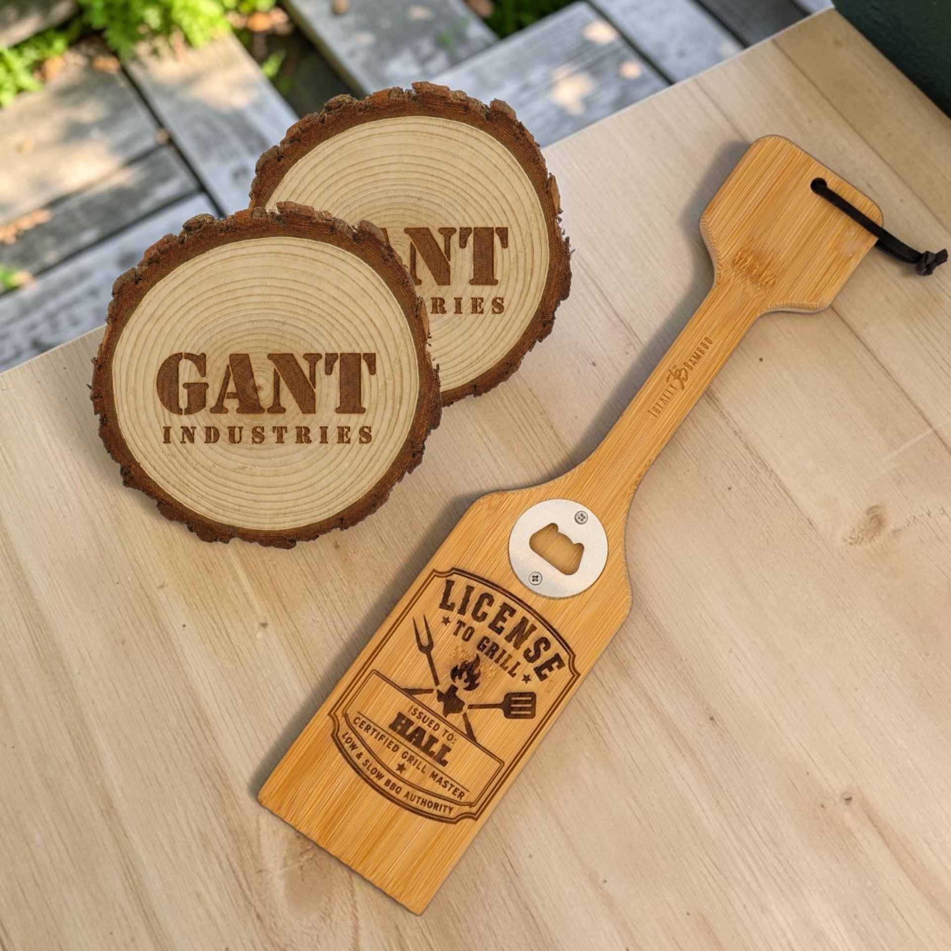 Laser-engraved wood coasters and bamboo grilling tool showing custom branding options